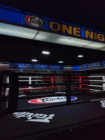 A boxing ring with 'Fairtex' branding and 'ONE NIGHT IN CHIANGMAI' signage. 4