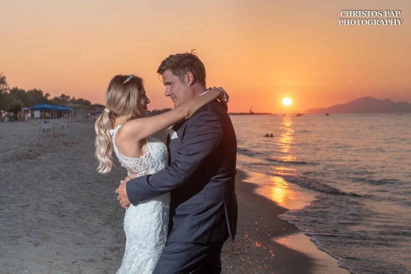 A couple dancing on a beach at sunset. 2