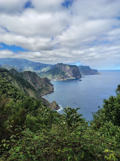 A coastal landscape with mountains, a coastline, and a view of the ocean. 1