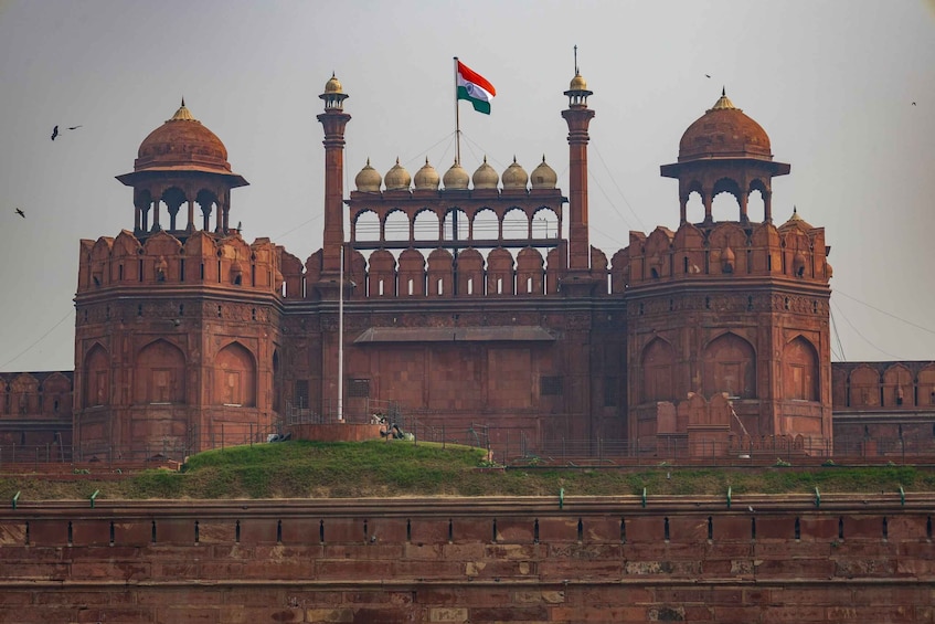 A large, historic building with domed towers and a flagpole. 5