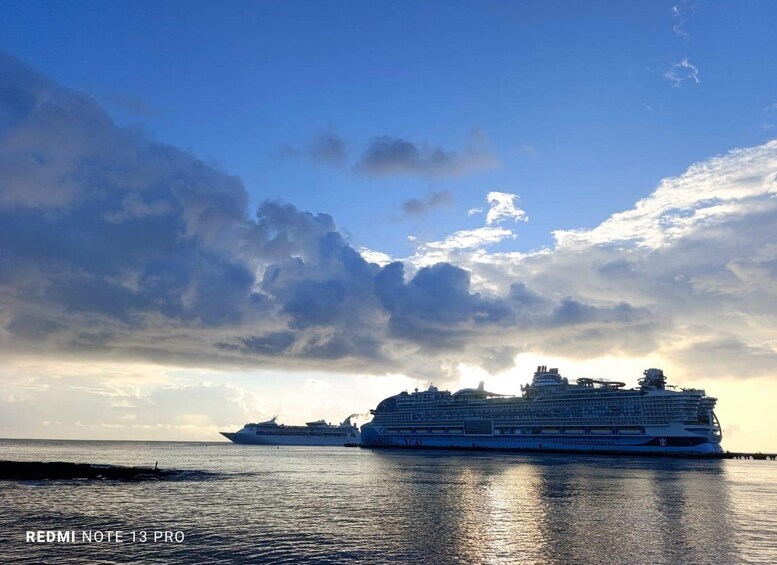 Two large cruise ships on calm waters with a partly cloudy sky. 3