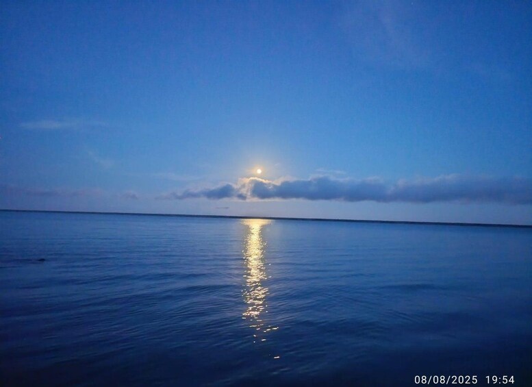 A calm sea at sunset with the sun reflecting on the water. 2