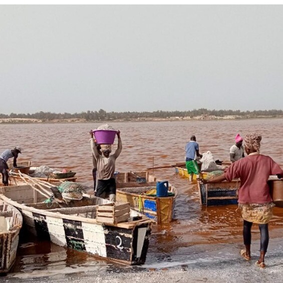 People working on boats in a river. 5