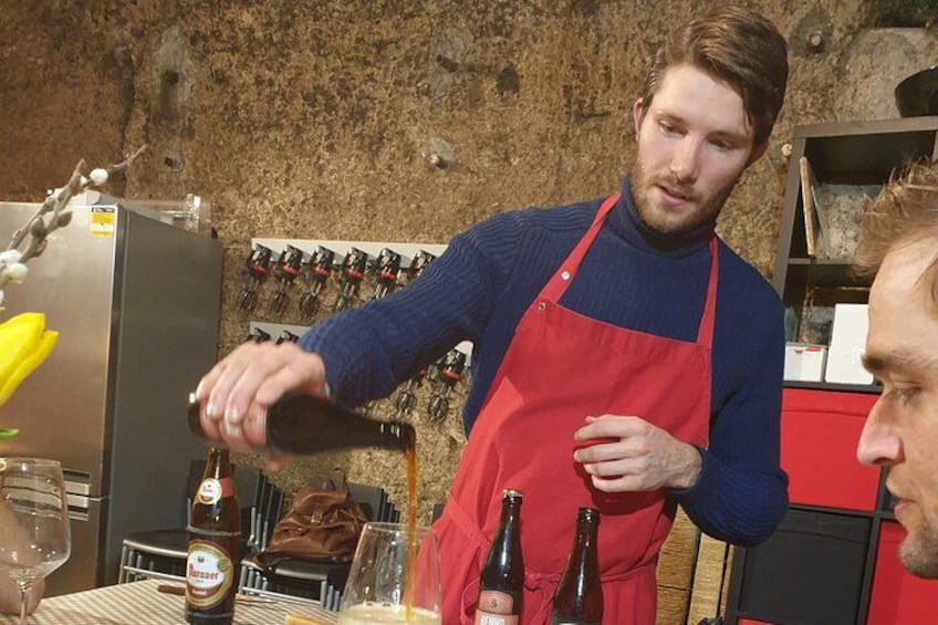 A person pouring a drink from a bottle into a glass. 3