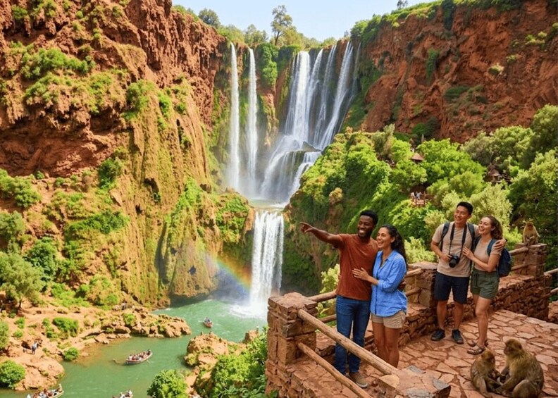 A group of people standing on a stone platform overlooking a multi-tiered waterfall in a lush, green canyon. 1