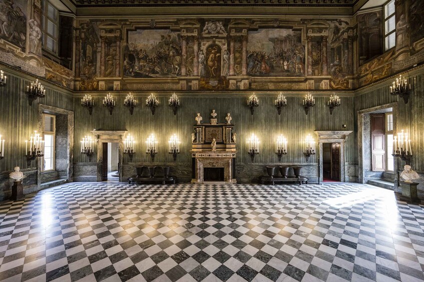 A grand hall with a checkered floor, ornate chandeliers, and a large fresco on the ceiling. 5