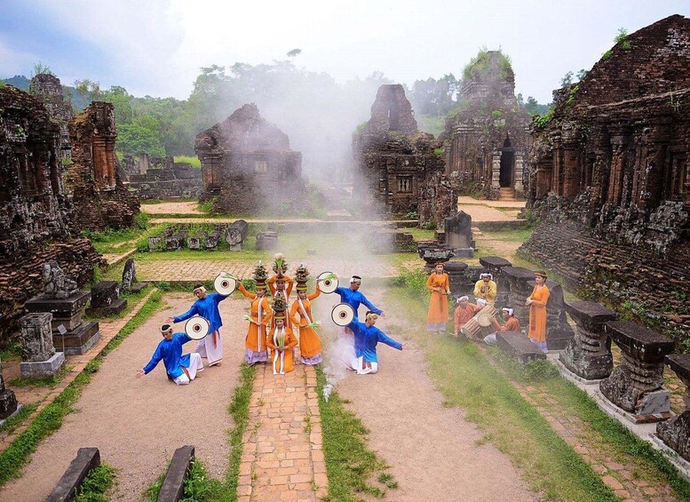 A group performing a traditional dance in an ancient temple complex. 4