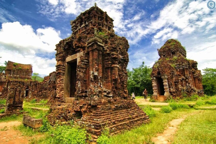 Ancient temple ruins with overgrown vegetation and a clear sky. 3