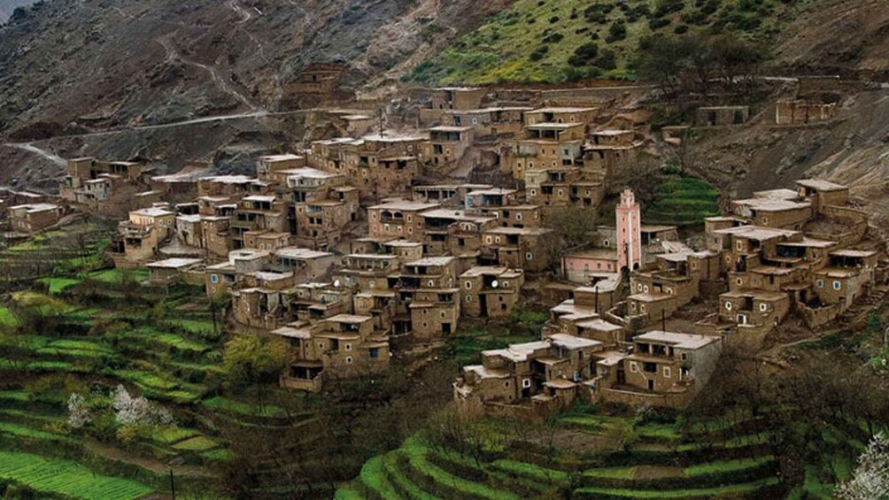 A terraced village with traditional mud-brick houses nestled in a mountainous landscape. 2