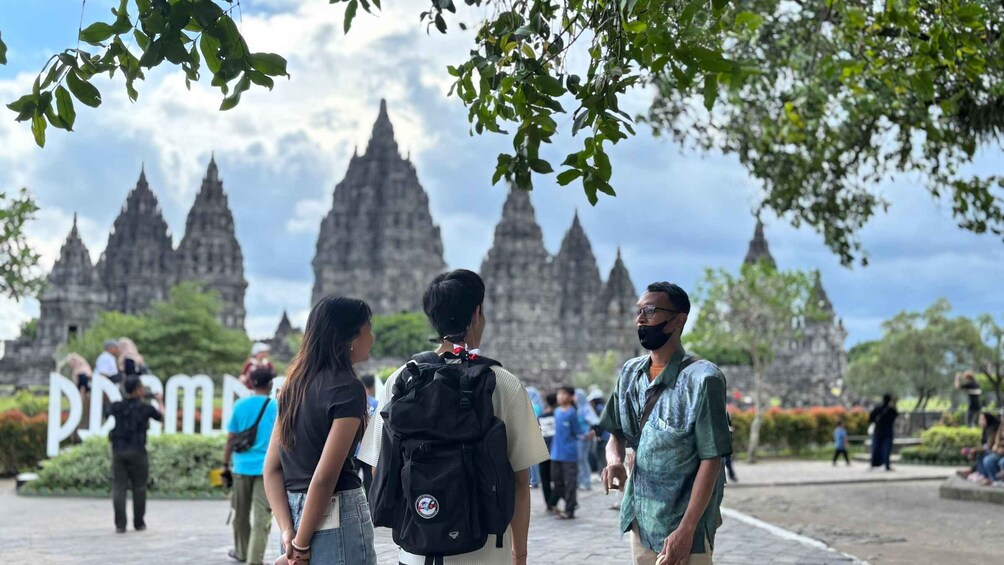 Tourists at a temple complex with intricate architecture. 2