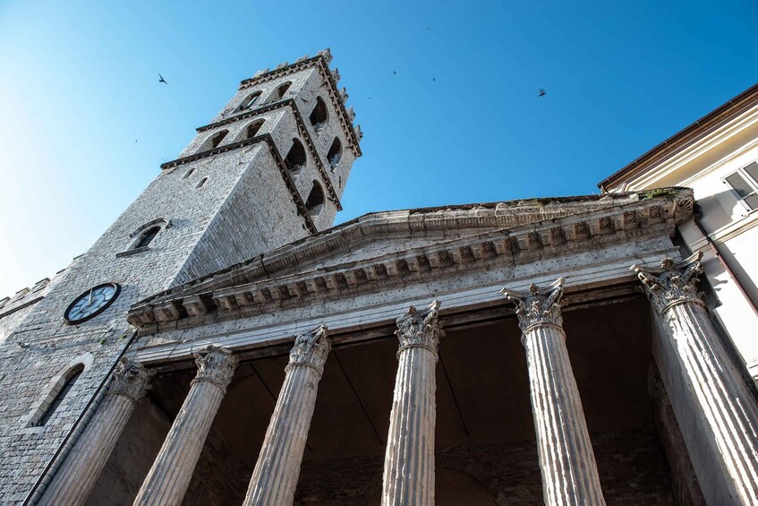 A historic building with a clock tower and columns. 4