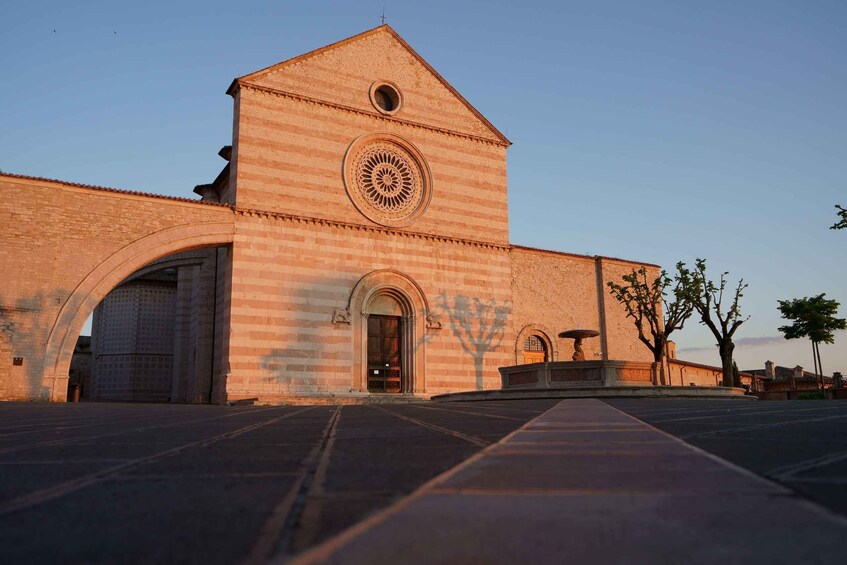 A historic building with a prominent circular window and arched entrance. 3