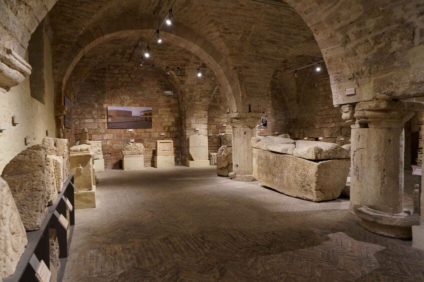 An ancient stone building with arched ceilings and columns. 5