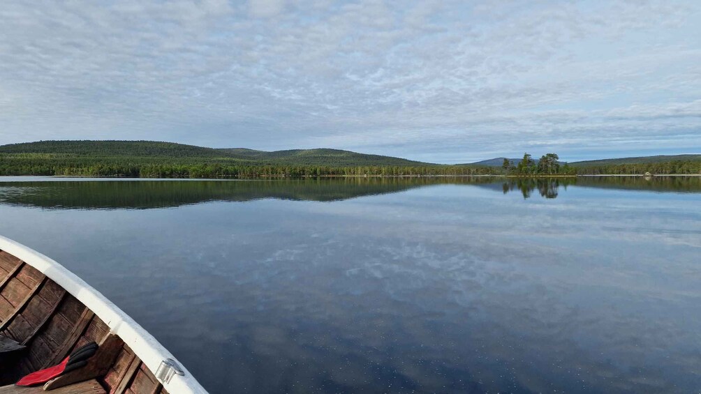 A calm lake with reflections of trees and hills. 4