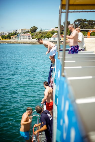 People on a boat near a dock, with a cityscape in the background. 5