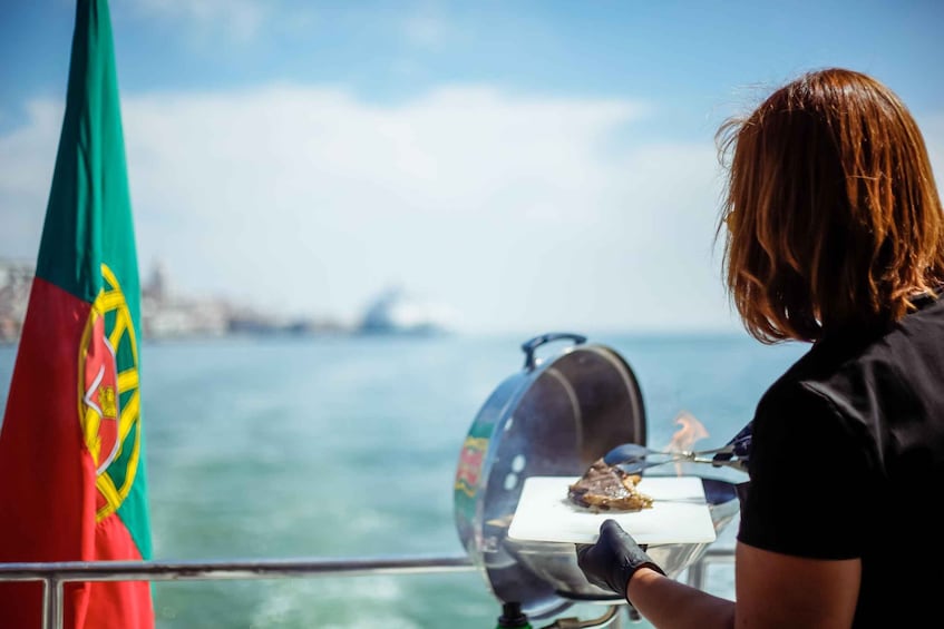 A person grilling meat on a boat with a flag in the background. 3