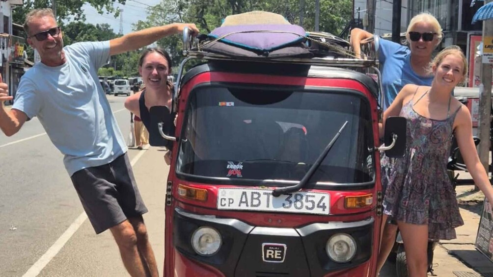 A red three-wheeled vehicle with a license plate CP ABT 3854 parked on a street. 3