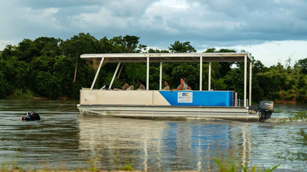A boat with passengers and a Yamaha outboard motor on a river. 3