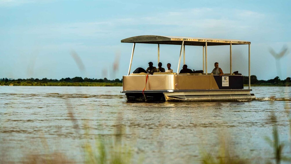 A boat with people on a calm river. 4