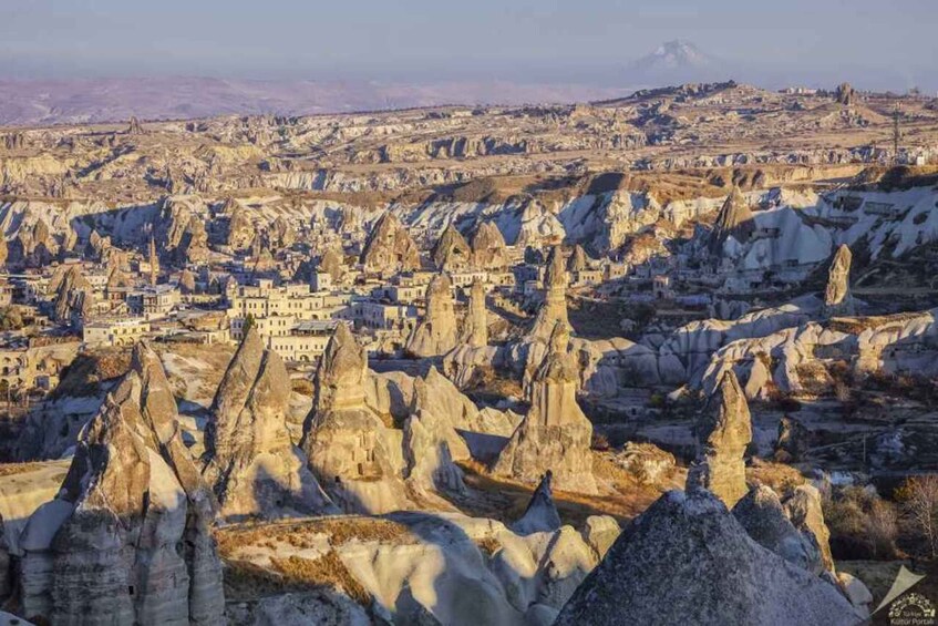 A town nestled among unique rock formations. 4