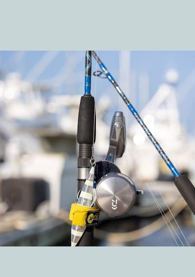A fishing rod with a reel and a tackle box. 3