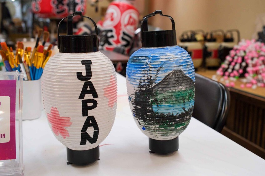 Two decorative lanterns with Japanese characters and a painted landscape. 1