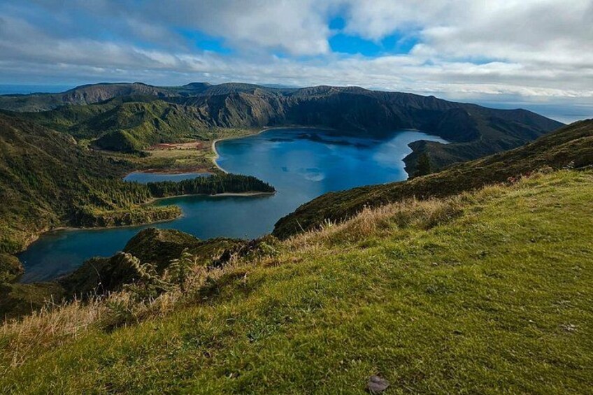 A mountainous landscape with a large lake surrounded by hills. 1