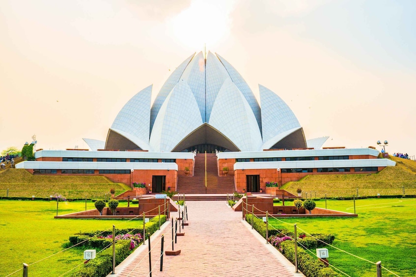 A large, lotus-shaped building with a central staircase and a surrounding garden. 2