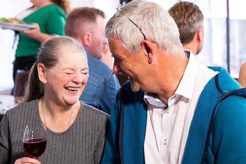 couple enjoying a laugh and a glass of wine at Hysterical Histories Cork 2