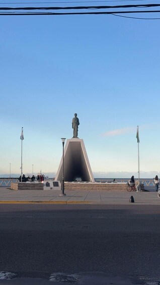 A statue on a pedestal with a clear sky in the background. 5