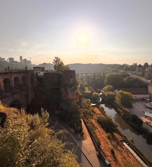 A river, a bridge, and a cityscape with buildings and trees. 2