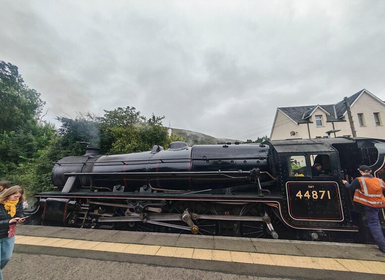 A black steam locomotive with the number 44871 at a station. 5