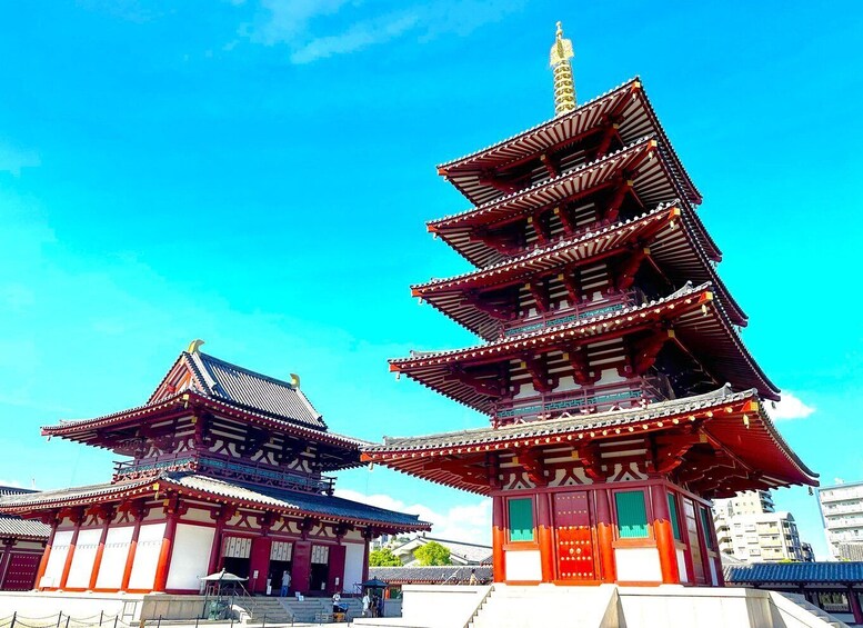 A traditional Japanese pagoda with multiple tiers, surrounded by a clear blue sky. 1