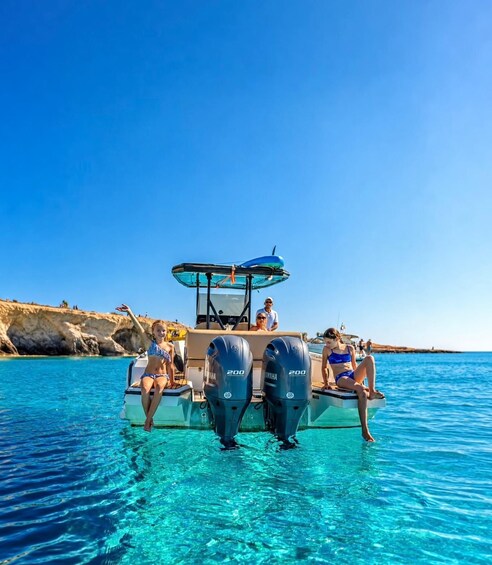 A boat with two Yamaha 200 outboard motors on clear turquoise water. 1