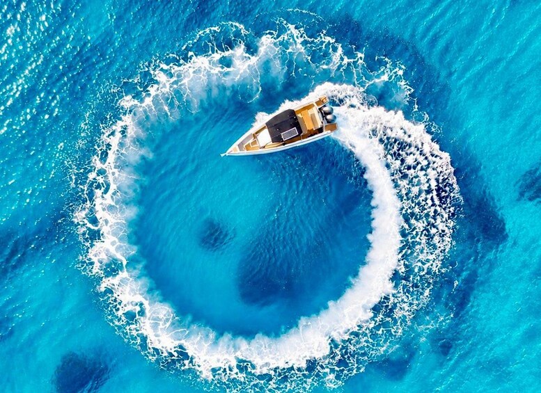 A boat creating a circular wake in the ocean. 2