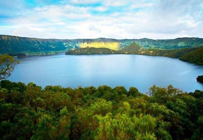 A lake surrounded by forested hills. 5