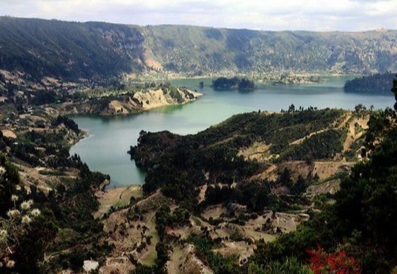 A lake surrounded by hills and sparse vegetation. 2