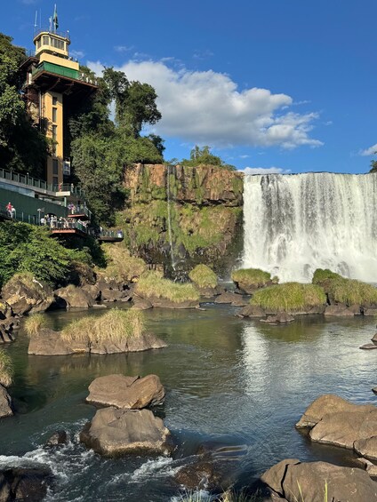 A waterfall, rocky riverbed, and a lookout tower. 5