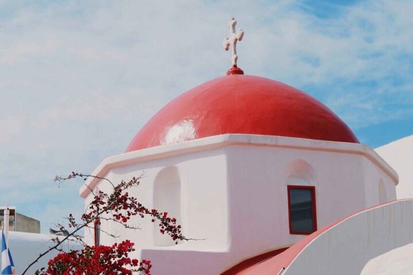 A white building with a red dome and a cross on top. 4