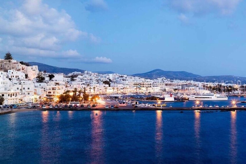 A coastal town with white buildings, a marina, and boats. 3