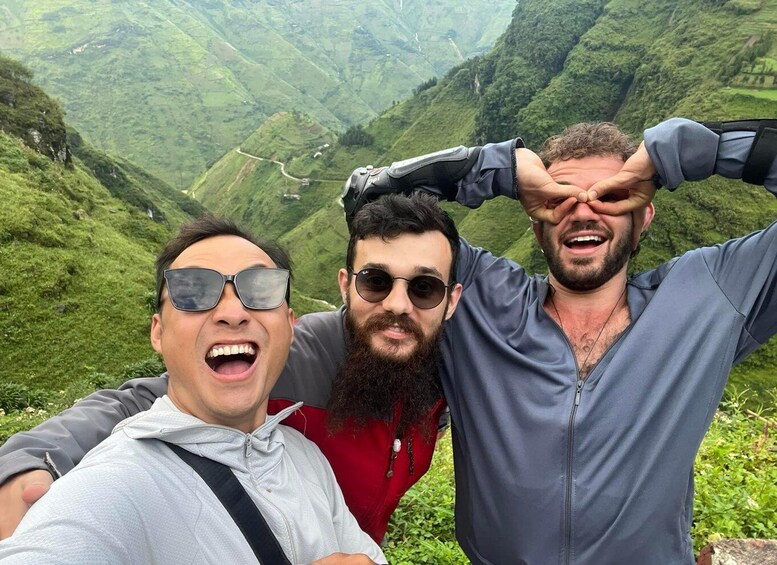 Three people taking a selfie with a mountainous landscape in the background. 5