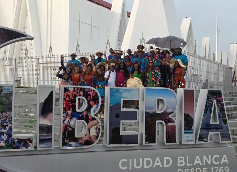 A group of people posing in front of a large sign with the word "CIUDAD BLANCA" and the year "1769". 1