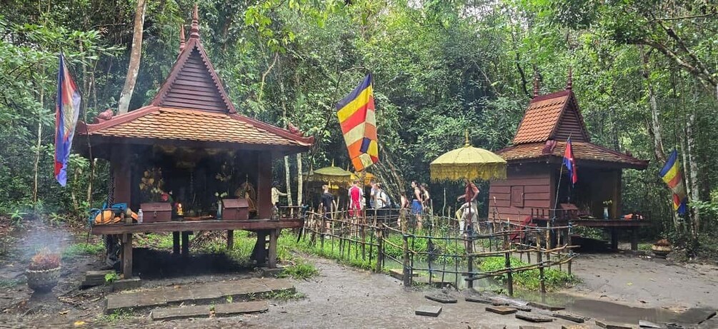 A temple complex with traditional architecture, surrounded by lush greenery. 4