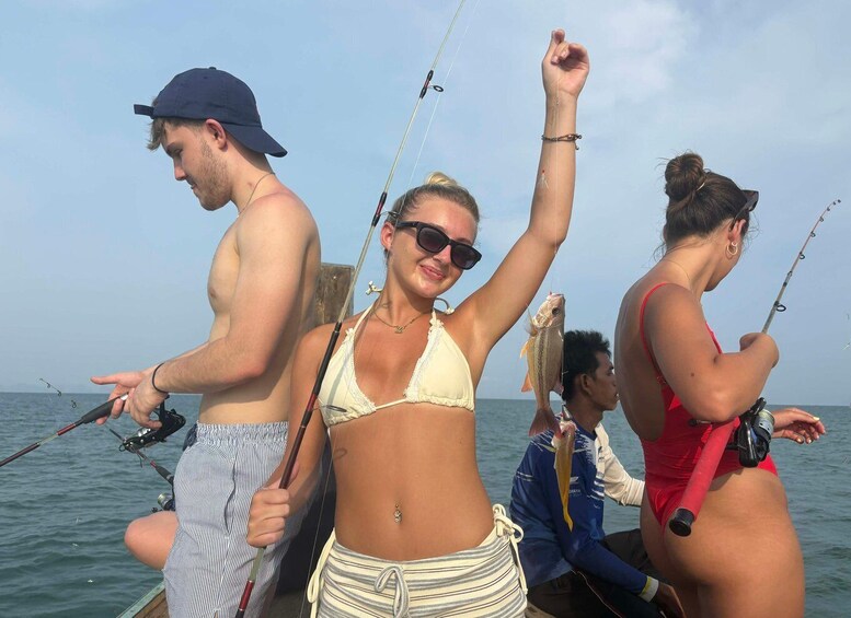 People fishing on a boat with the sea in the background. 4