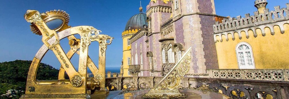 A historic building with ornate golden sculptures and a large dome. 3