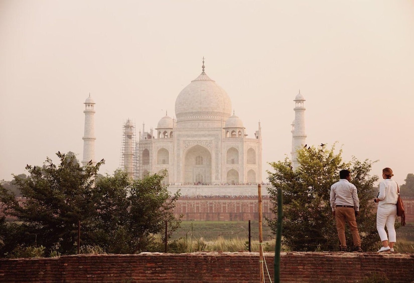 The Taj Mahal with a couple standing in the foreground. 2