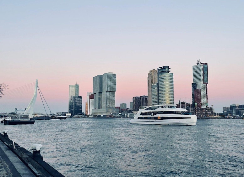 A waterfront cityscape with modern skyscrapers and a sailboat on the water. 1