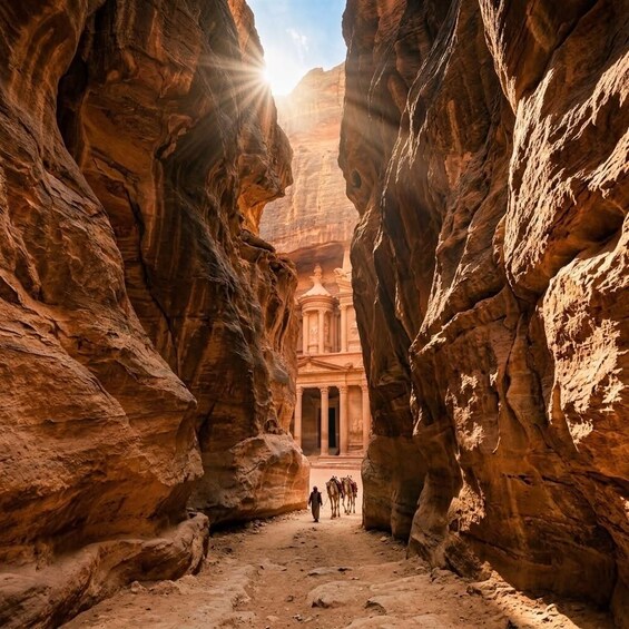 A narrow canyon with towering rock walls and a building with columns at the end. 2