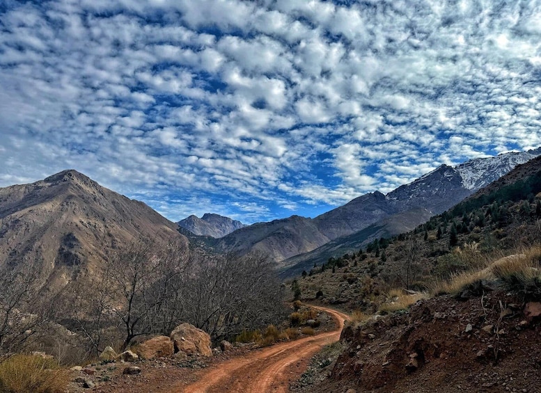 A mountainous landscape with a dirt road winding through it. 4