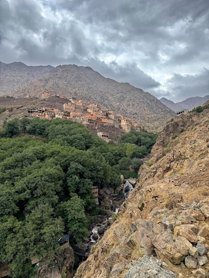 A mountainous village with terraced buildings and a river flowing through a valley. 3